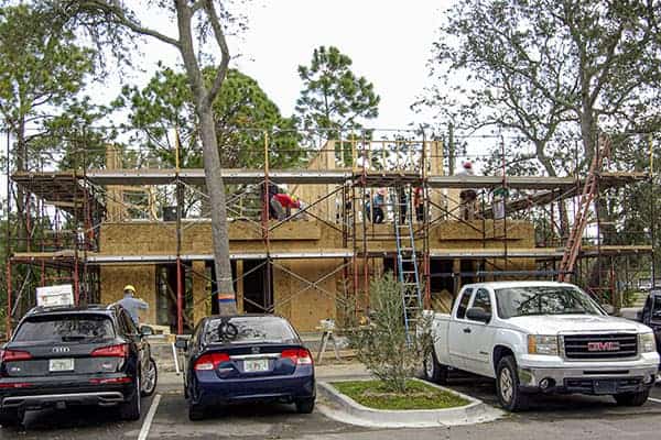 wood frame of home surrounded by scaffolding