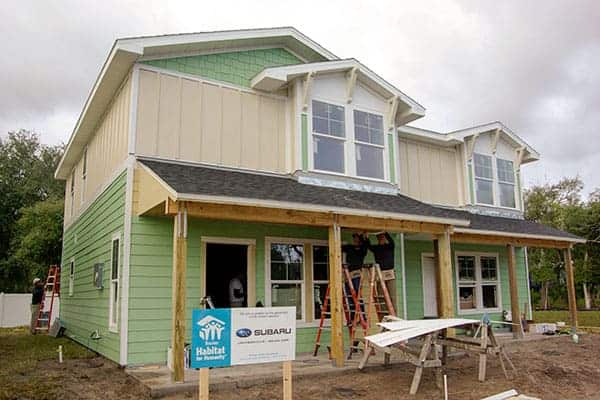 Green and tan painted home under construction