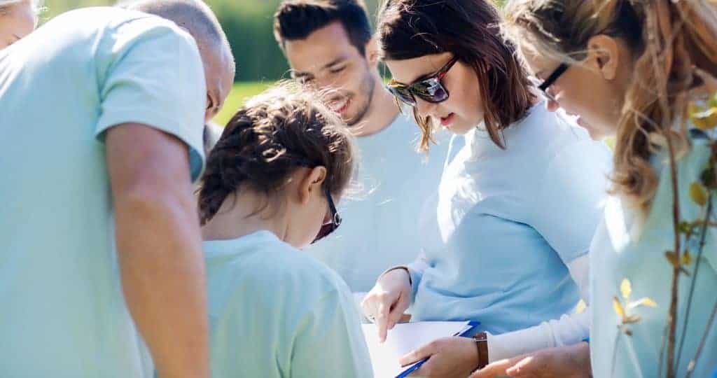 Group of volunteers looking at clipboard