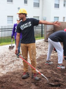 Eric holding shovel on the construction site
