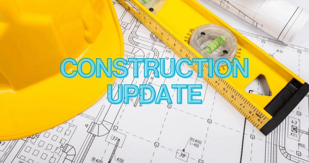 The words "Construction Update" written over image of architectural drawings, a hard hat and a level