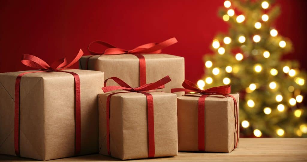 Christmas Gifts Wrapped in brown paper with red ribbons