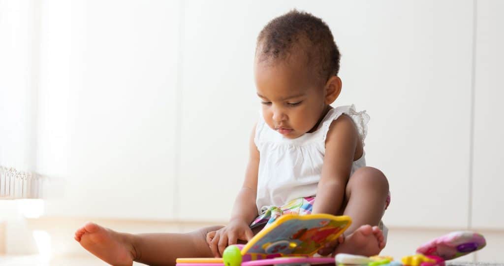 Little girl on the floor with book