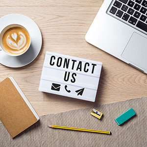 Contact us writing in lightbox lying on desk