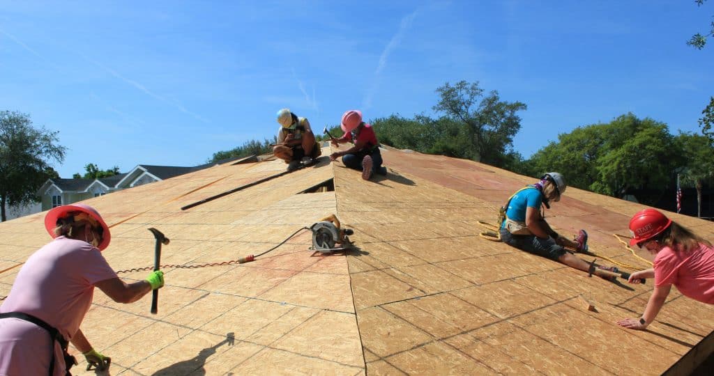 Women Build volunteers nailing on roof