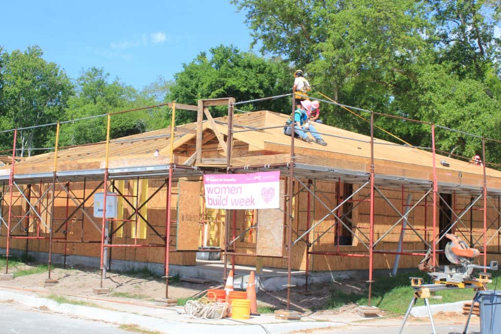Home under construction with Women Build Week banner