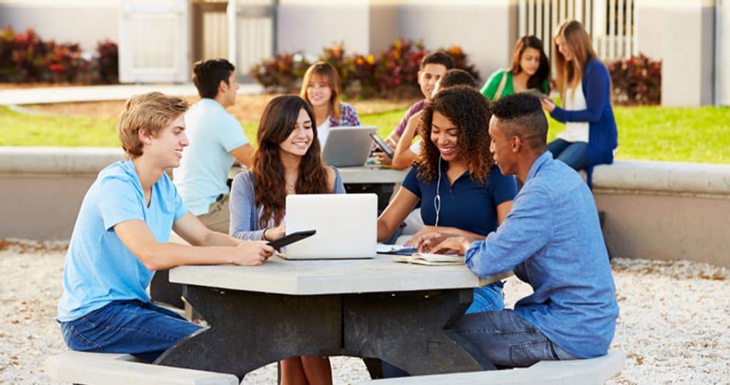 Students sitting at table on campus