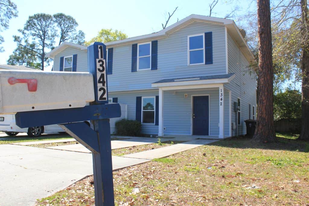 Two-story blue duplex being renovated by Beaches Habitat for Humanity.