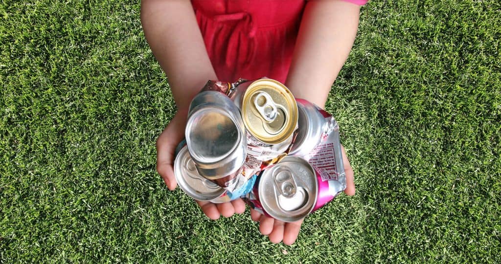 Crushed aluminum cans in hands