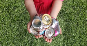 Crushed aluminum cans in hands