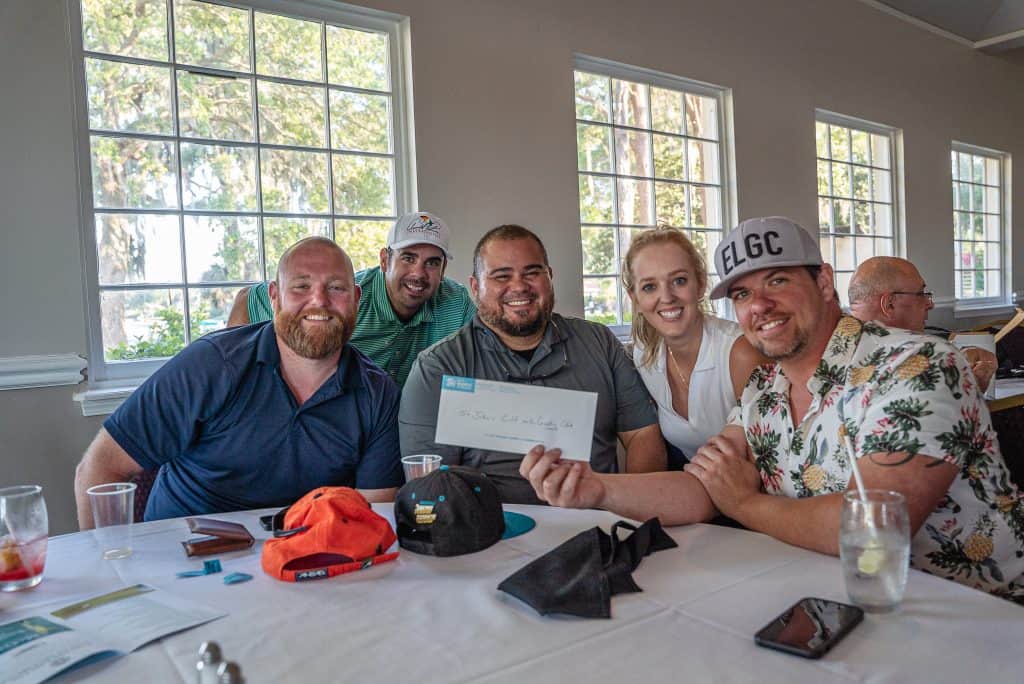 Members of Habitat Young Professionals receiving a prize won at Beaches Habitat's Builders Classic Golf Tournament.