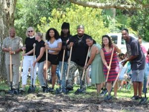 Group of people holding shovels