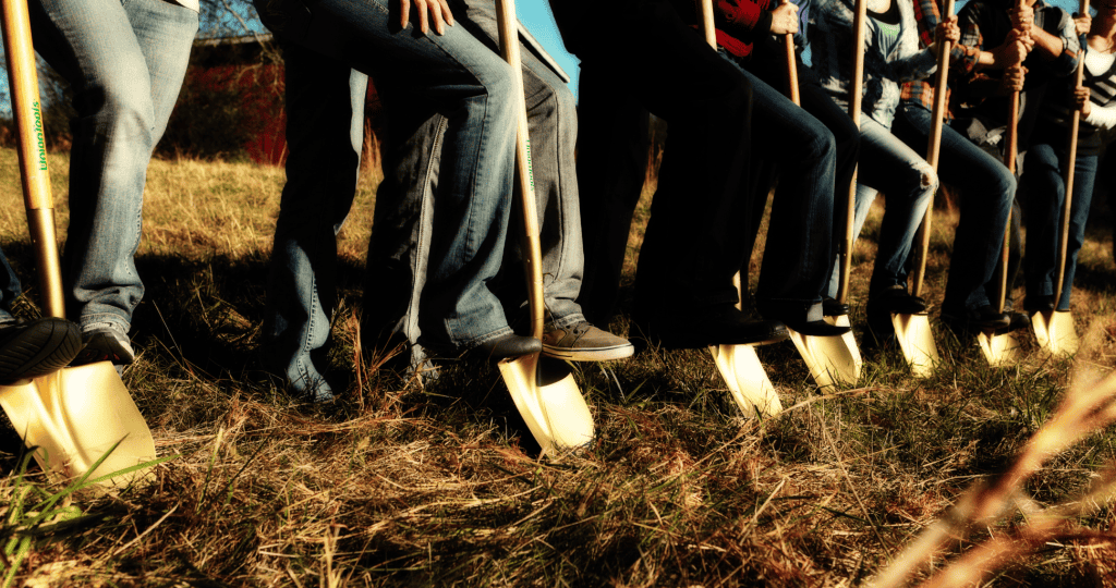Row of people with gold shovels