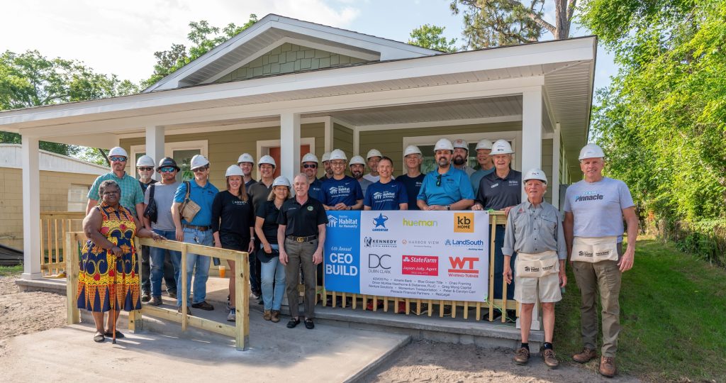 Group of local executives and homeowner at Beaches Habitat CEO Build