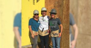 Mary Anne and fellow volunteers smiling together on a Beaches Habitat build day