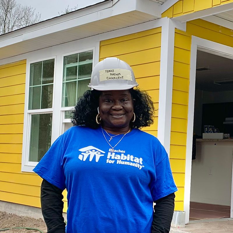 Woman wearing hard hat and blue Beaches Habitat shirt